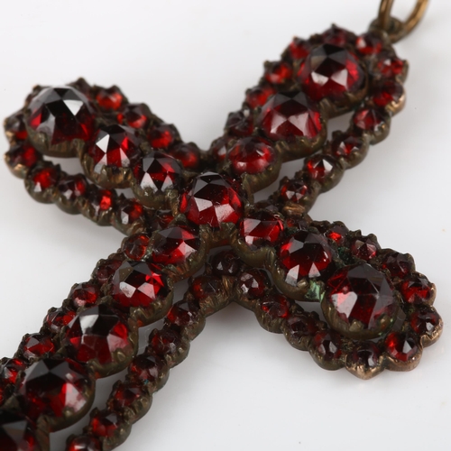 181 - A Victorian Bohemian faceted garnet cross pendant, unmarked yellow metal settings, pendant height ex... 