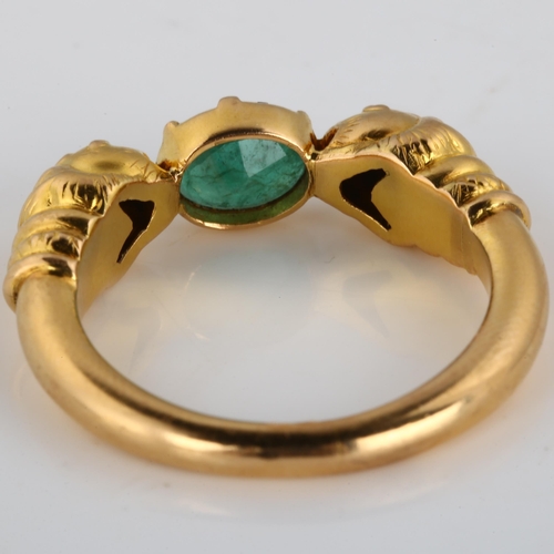 186 - A large 18ct gold emerald lion-head ring, after the Ancient Greek design, set with oval mixed-cut em... 