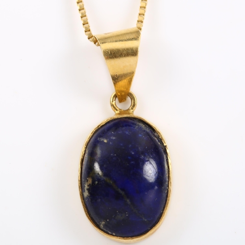 188 - An Egyptian lapis lazuli pendant necklace, unmarked high carat gold settings with oval cabochon lapi... 