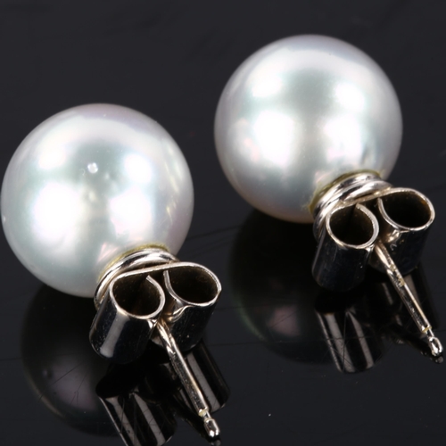 191 - A pair of 18ct white gold whole pearl earrings, set with 13.8mm pearls and stud fittings, hallmarks ... 