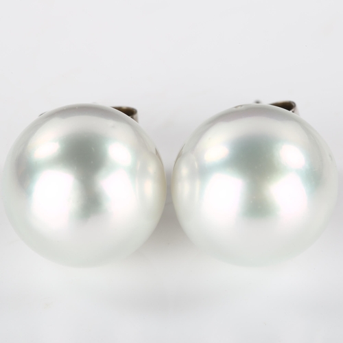 191 - A pair of 18ct white gold whole pearl earrings, set with 13.8mm pearls and stud fittings, hallmarks ... 