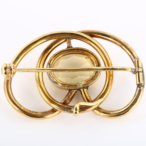 194 - An Art Nouveau citrine openwork brooch/pendant, in the style of Murrle Bennett, unmarked yellow meta... 