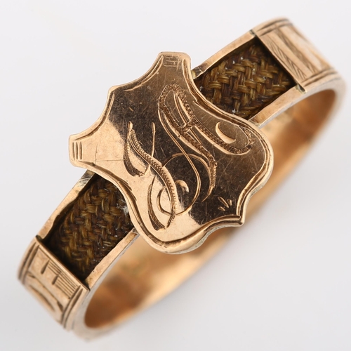 195 - An Antique 9ct rose gold memorial band ring, with shield motif and woven hair shank, inscribed 