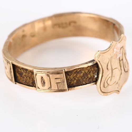 195 - An Antique 9ct rose gold memorial band ring, with shield motif and woven hair shank, inscribed 