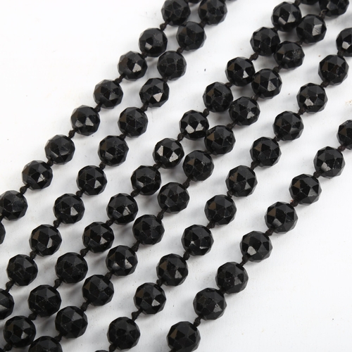 206 - A long single-strand faceted jet bead necklace, bead diameter 11.3mm, necklace length 170cm, 201.9g