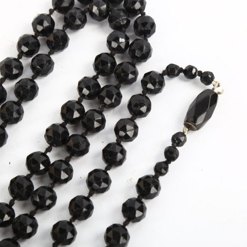 206 - A long single-strand faceted jet bead necklace, bead diameter 11.3mm, necklace length 170cm, 201.9g