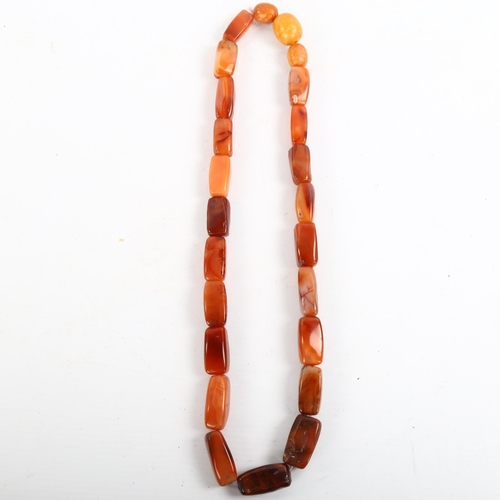 207 - A carnelian and butterscotch amber bead necklace, largest amber bead length 21.4mm, necklace length ... 