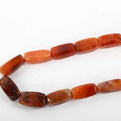 207 - A carnelian and butterscotch amber bead necklace, largest amber bead length 21.4mm, necklace length ... 