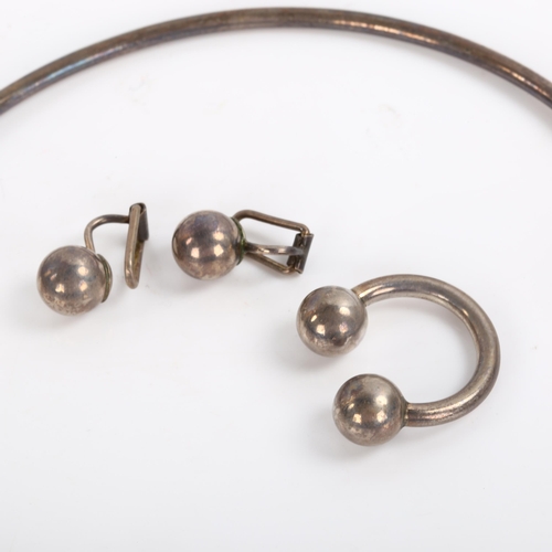 213 - A 1960s silver demi-parure, comprising neck torque, ring and pair of clip-on earrings, by Charles Fr... 