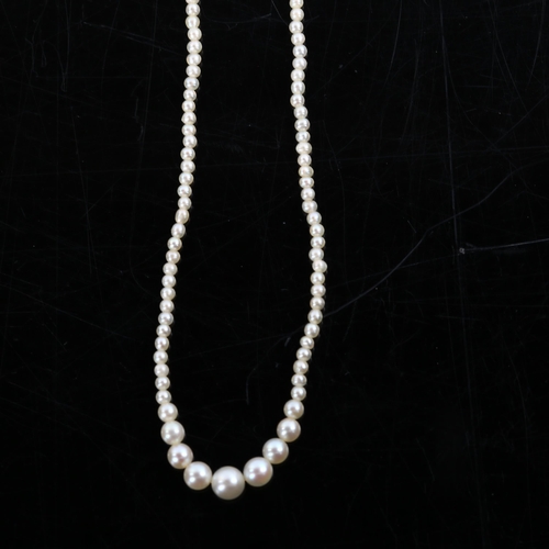 226 - A fine graduated single-strand seed pearl necklace, with unmarked white metal diamond set clasp, pea... 