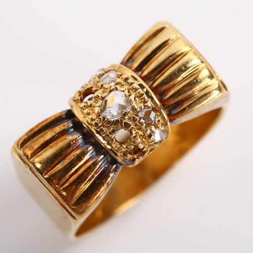 235 - A late 20th century diamond bow ring, unmarked gold settings with rose-cut diamonds, setting height ... 