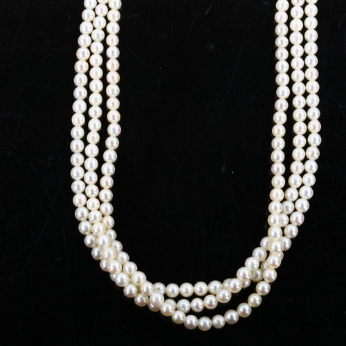 283 - A Vintage triple-strand pearl necklace, with unmarked white metal garnet and diamond cluster clasp, ... 