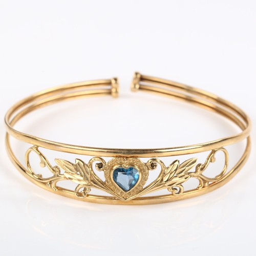 286 - A modern 9ct rose gold blue topaz heart torque bracelet, openwork floral design, setting height 13.9... 