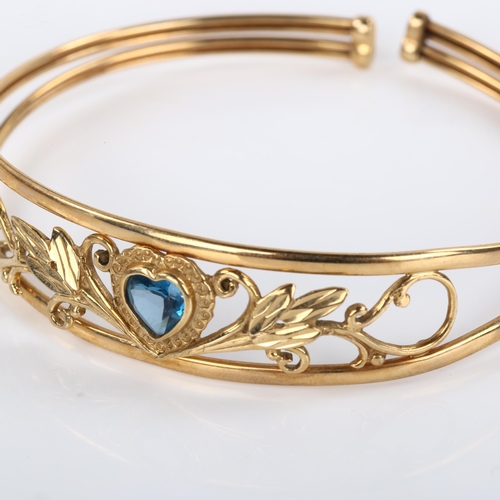 286 - A modern 9ct rose gold blue topaz heart torque bracelet, openwork floral design, setting height 13.9... 