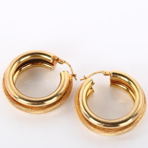 300 - A pair of 9ct gold hollow hoop earrings, textured and polished design, diameter 31.6mm, 9g