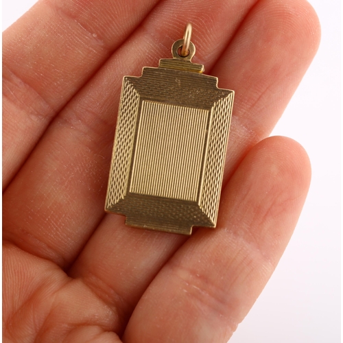 309 - An Art Deco 9ct gold photo locket pendant, stepped rectangular form with engine turned decoration an... 