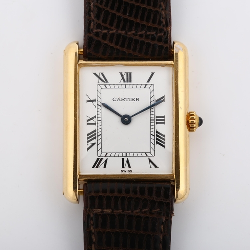 14 - CARTIER - a mid-size 18ct gold Tank quartz wristwatch, white enamel dial with Roman numeral hour mar... 