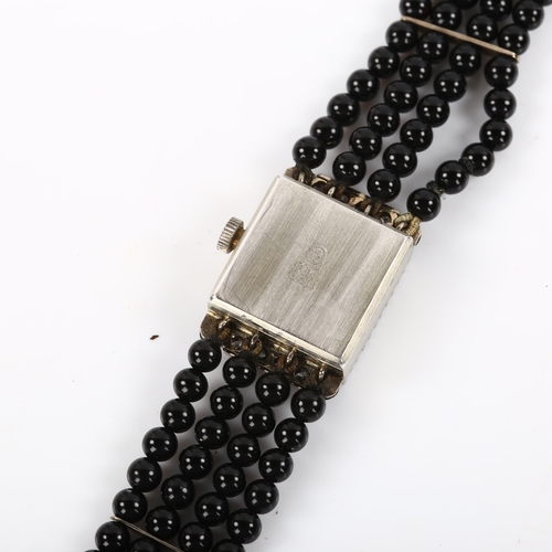 19 - EXQUISIT - a lady's 18ct white gold diamond and jet mechanical cocktail bracelet watch, circa 1960s,... 