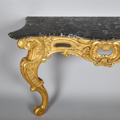 1020 - A 19th century French Rococo style console table, carved and scrolled giltwood frame with original m... 