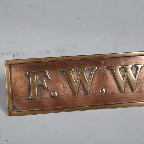 1030 - F. W. Woolworth & Co. Limited relief cast-bronze name plaque on bronze brackets, 63.5cm x 7.5cm