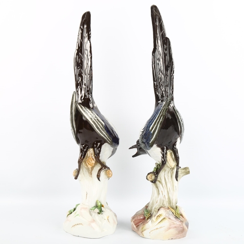 1034 - A large pair of Meissen porcelain magpies on naturalistic bases, height 52cm