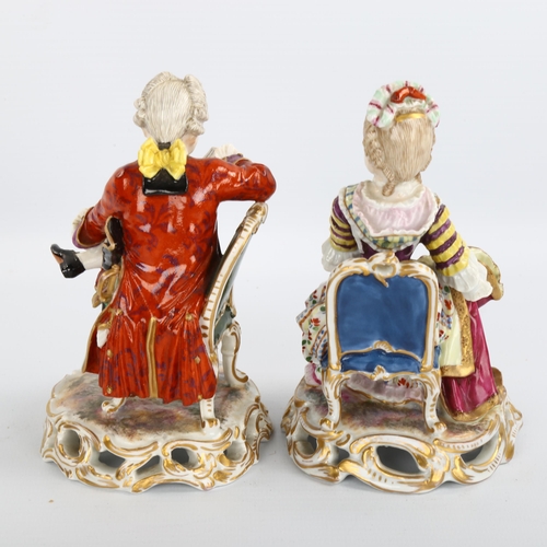 1061 - A pair of 19th century porcelain figures of seated children sewing and reading, no factory marks, he... 