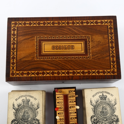 1070 - A Tunbridge Ware besique rosewood and parquetry inlaid games box, the interior fitted with cards and... 