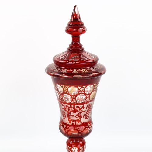 1080 - A 19th century Bohemian ruby overlay glass goblet and cover, height 32cm