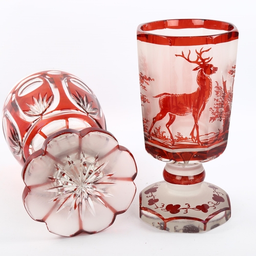 1081 - 2 Bohemian ruby overlay glass goblets, 1 with etched hunting scenes, largest height 18cm (2)