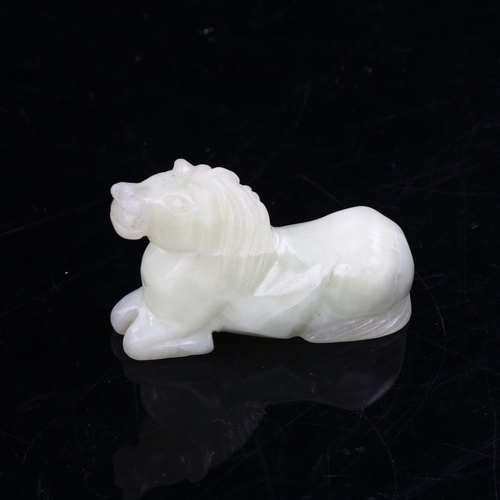 1089 - A Chinese pale green jade horse, length 8cm