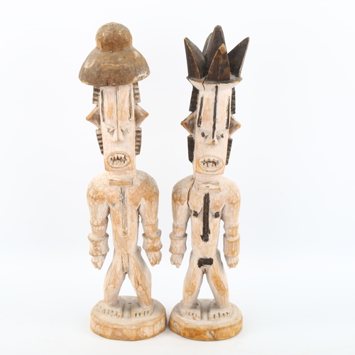 1125 - A pair of African carved and painted wood Tribal figures, height 32cm