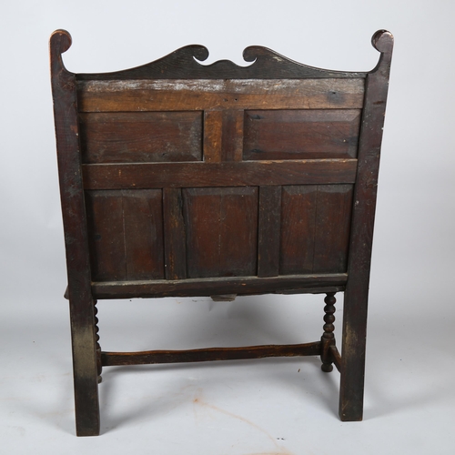 1133 - An 18th century oak settle of small size, with lozenge carved 5-panel back and bobbin turned support... 