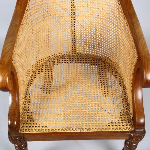 1136 - A 19th century mahogany framed Gillows style Bergere tub chair, with cane panel back, squab seat and... 