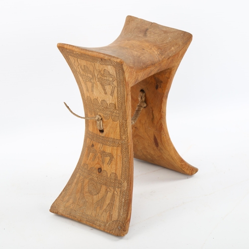 1154 - An African wood neck rest with engraved sides, height 19cm