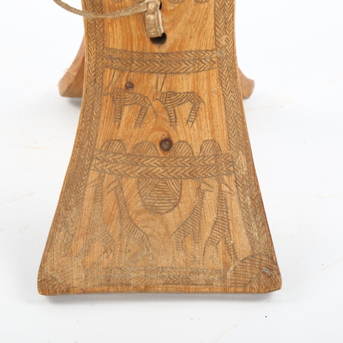 1154 - An African wood neck rest with engraved sides, height 19cm