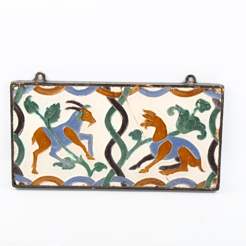 1166 - An unusual moulded pottery tile with animal designs, 14.5cm x 28cm, framed (A/F)