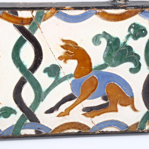 1166 - An unusual moulded pottery tile with animal designs, 14.5cm x 28cm, framed (A/F)