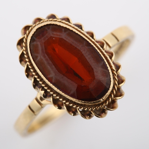 362 - A 9ct gold garnet dress ring, set with oval step-cut garnet within rope twist surround, setting heig... 