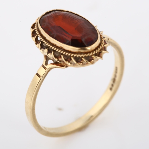 362 - A 9ct gold garnet dress ring, set with oval step-cut garnet within rope twist surround, setting heig... 