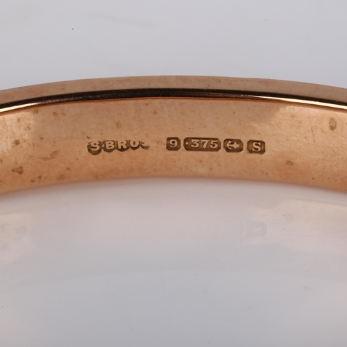 369 - An early 20th century 9ct rose gold hinged bangle, with engraved leaf decoration, maker's marks S Br... 