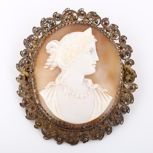 371 - A Victorian shell cameo brooch, depicting profile of Greek lady, in unmarked silver filigree frame, ... 