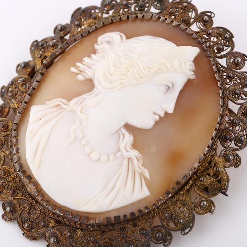 371 - A Victorian shell cameo brooch, depicting profile of Greek lady, in unmarked silver filigree frame, ... 