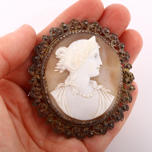 371 - A Victorian shell cameo brooch, depicting profile of Greek lady, in unmarked silver filigree frame, ... 