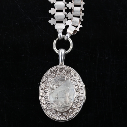 374 - A Victorian Aesthetic Movement photo locket pendant necklace, unmarked silver relief embossed and en... 