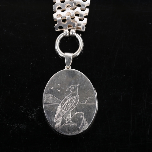 375 - A Victorian bird of prey photo locket pendant necklace, unmarked silver settings on unmarked white m... 