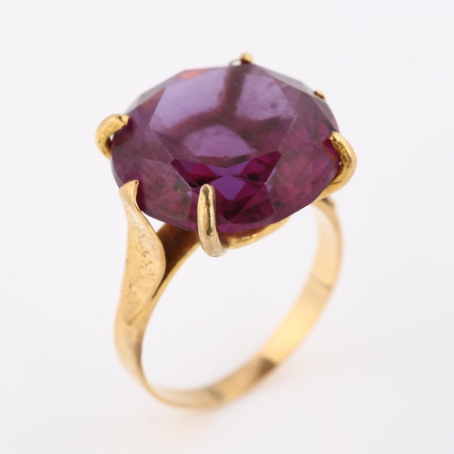 387 - A Middle Eastern synthetic sapphire dress ring, unmarked gold settings with leaf shoulders, sapphire... 