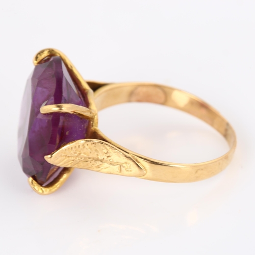 387 - A Middle Eastern synthetic sapphire dress ring, unmarked gold settings with leaf shoulders, sapphire... 