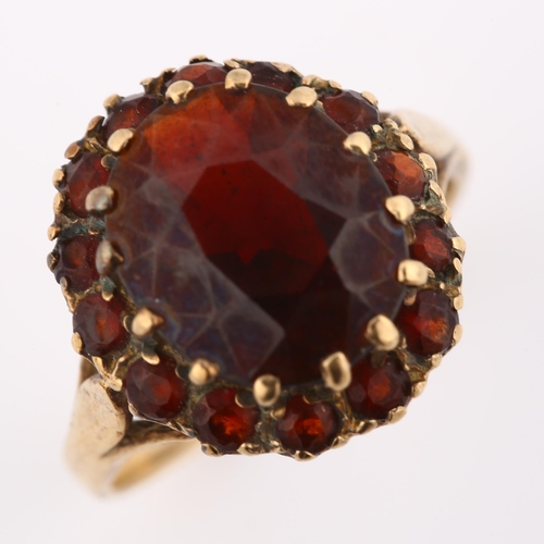 389 - A late 20th century 9ct gold garnet cluster dress ring, setting height 16.6mm, size O, 4.6g