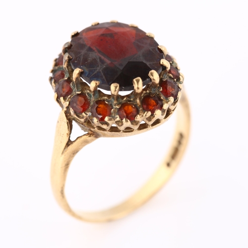 389 - A late 20th century 9ct gold garnet cluster dress ring, setting height 16.6mm, size O, 4.6g