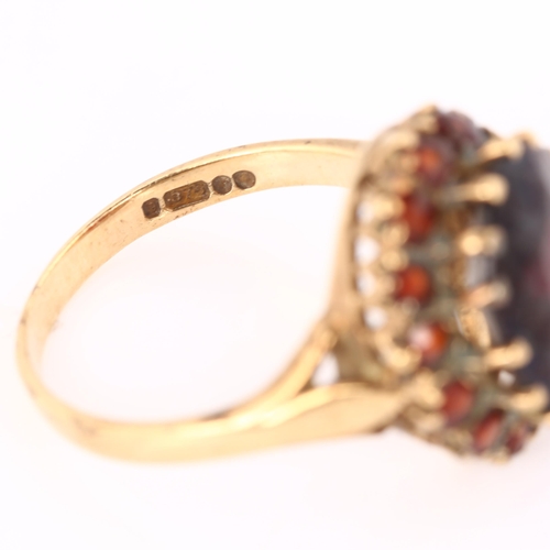 389 - A late 20th century 9ct gold garnet cluster dress ring, setting height 16.6mm, size O, 4.6g